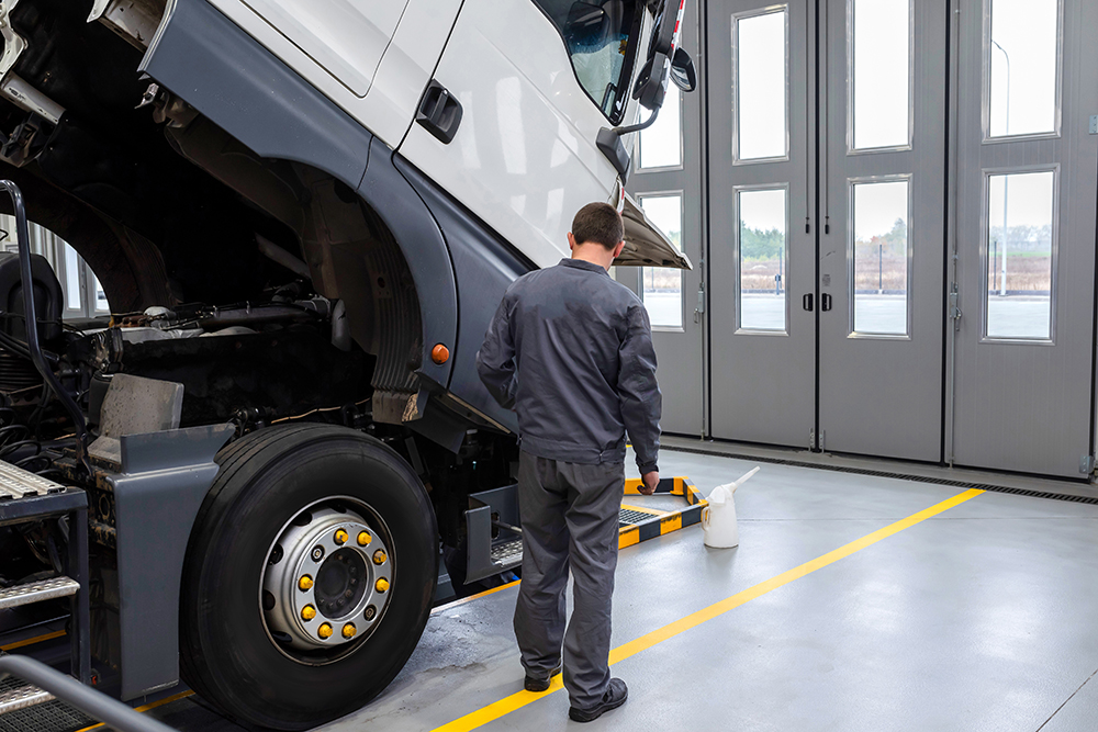 Auto,Mechanic,Checking,The,Truck,In,The,Garage.,Servicing,And
